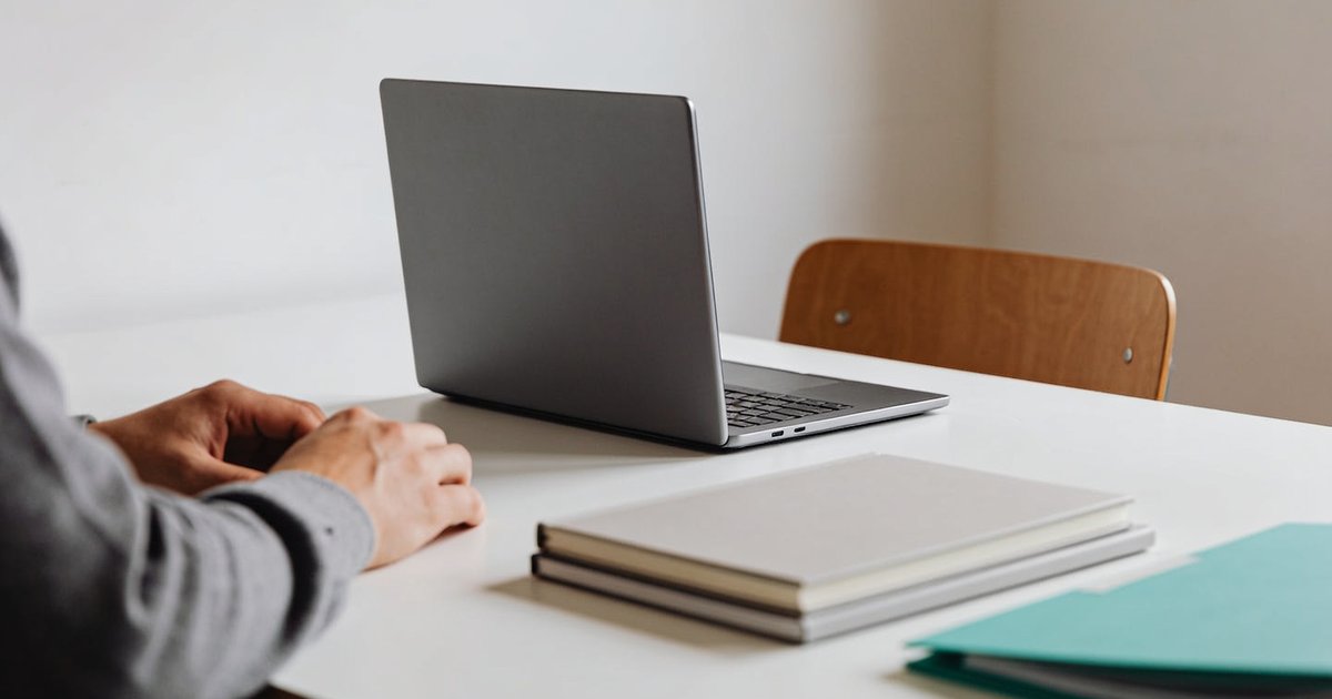 A tidy workspace at a medium-sized business, with a laptop and documents